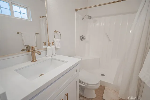 a large bed sitting in a bedroom next to a window