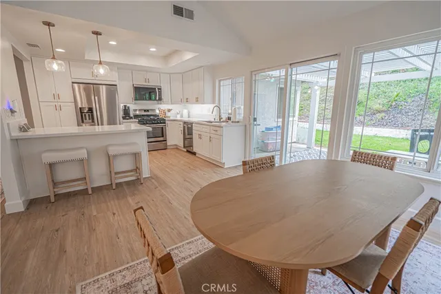 a living room with kitchen island furniture and a wooden floor
