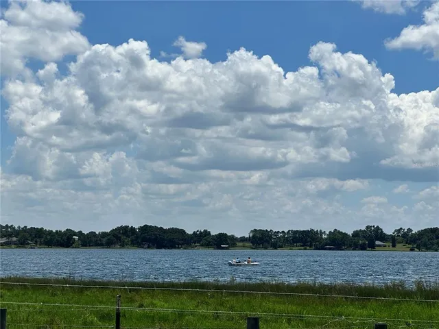 a view of a lake with houses in the background