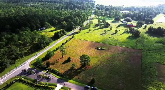 an aerial view of a wooden deck and lake view