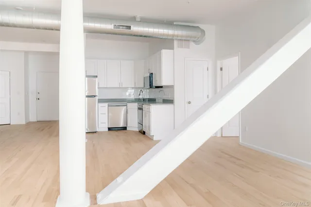 a view of a kitchen with wooden floor