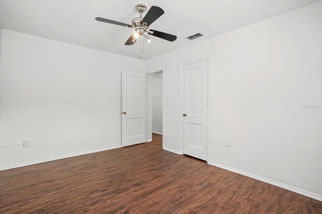 720 West Webster Avenue Winter Park, FL 32789 - Photo 16 of 22 an empty room with wooden floor and ceiling fan