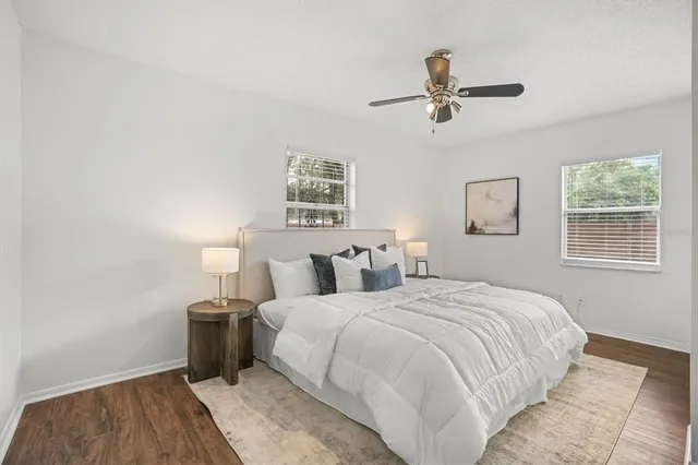 a bedroom with a bed and a night stand