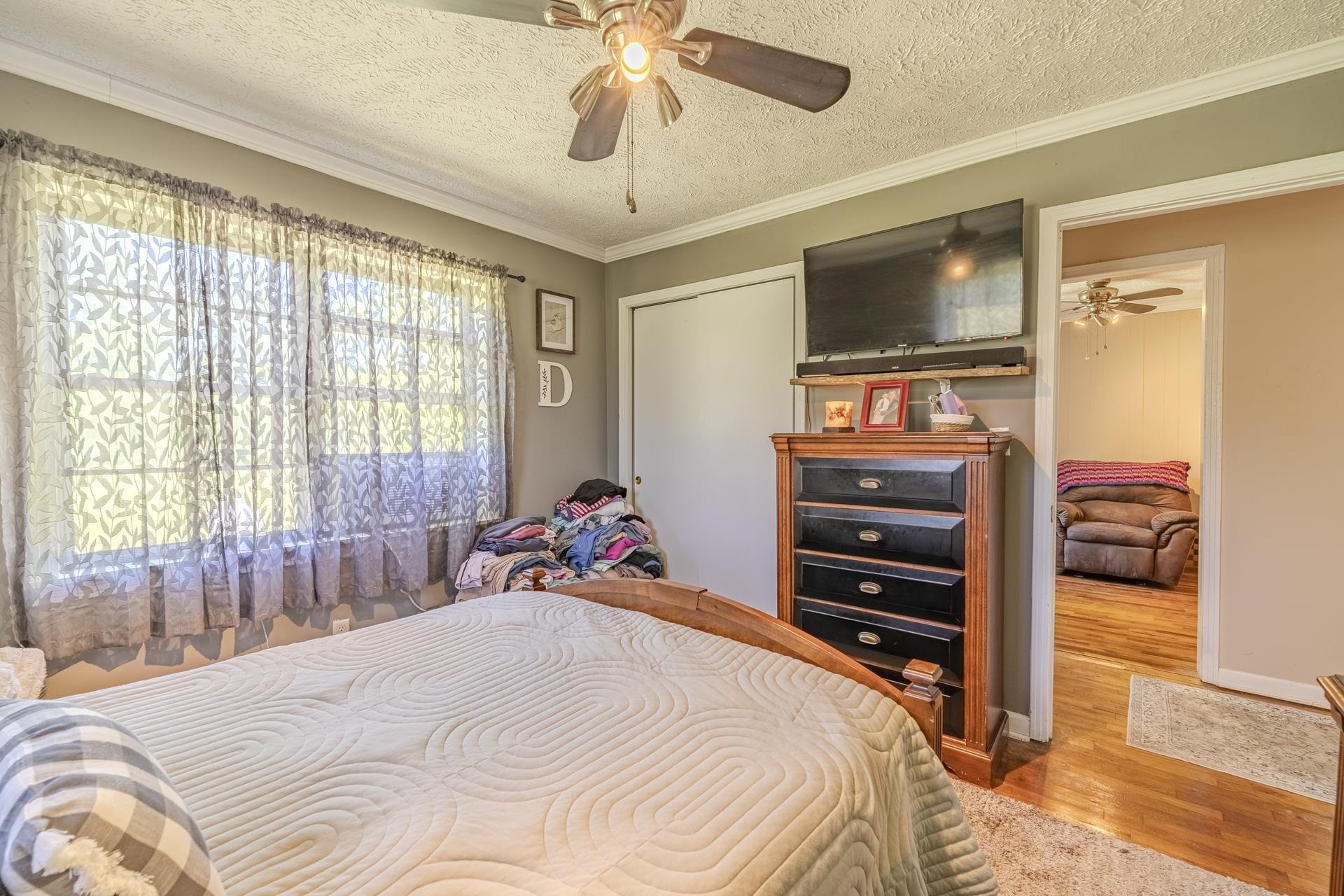 2884 Sandy Flat Road Bethel Springs, TN 38315 - Photo 30 of 40 a bedroom with a bed and a flat tv screen on dresser