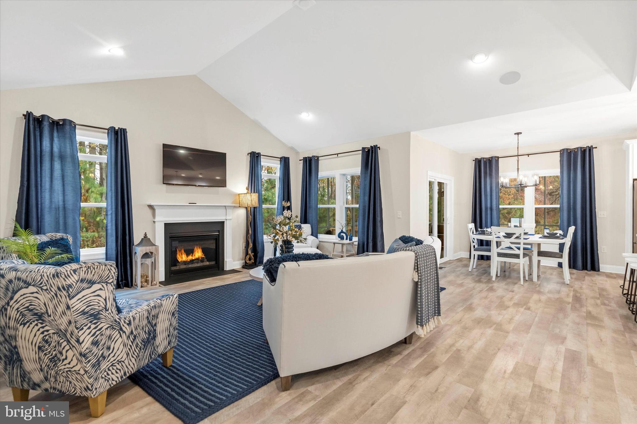 25021 Trinity Road, Unit 83 Lincoln, DE 19960 - Photo 18 of 42 a living room with furniture a flat screen tv and a fireplace