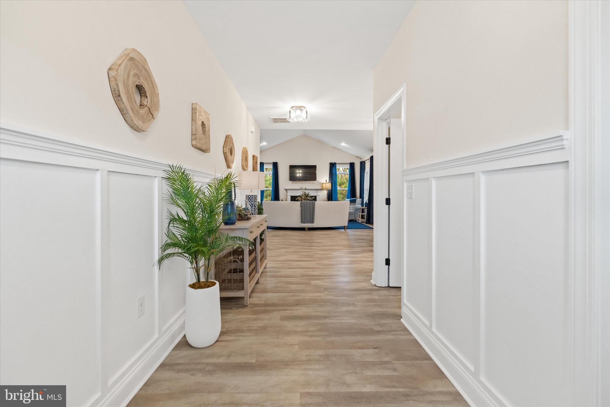 25021 Trinity Road, Unit 83 Lincoln, DE 19960 - Photo 8 of 42 a hallway with wooden floor and potted plant
