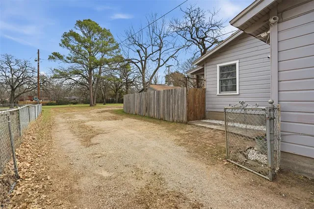 a backyard of house with large trees