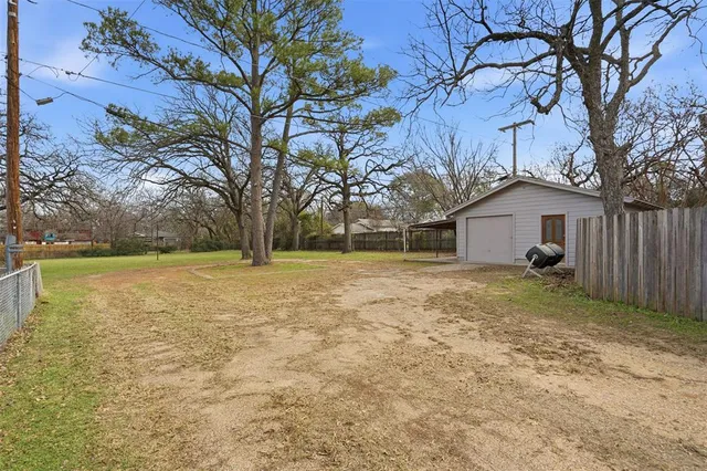 a backyard of a house with table and chairs