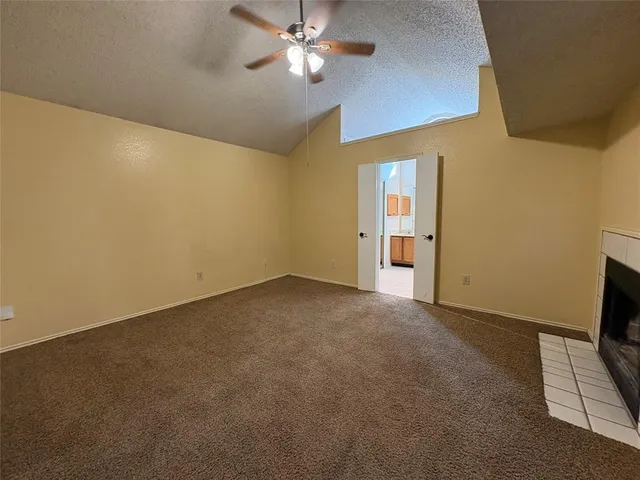 an empty room with a empty space and a ceiling fan
