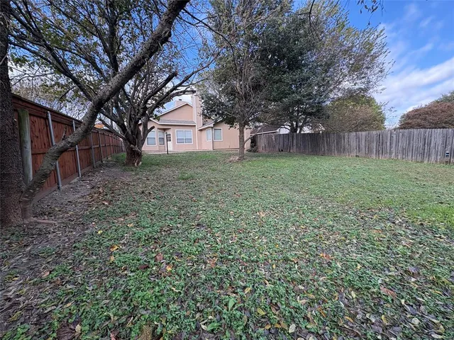 a tree in the garden of a house