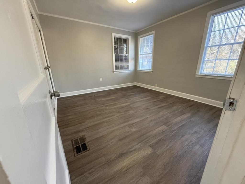 994 Hale Road Memphis, TN 38116 - Photo 16 of 24 Spare room featuring ornamental molding and dark wood finished floors