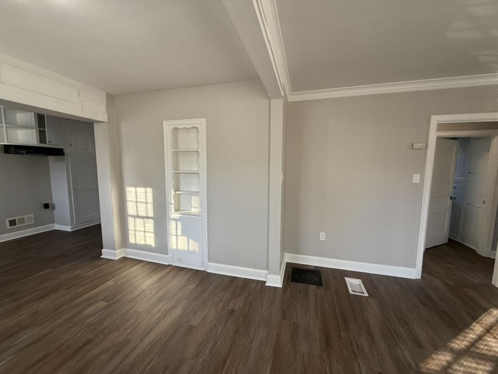 994 Hale Road Memphis, TN 38116 - Photo 10 of 24 Unfurnished living room with dark wood-type flooring and built in features