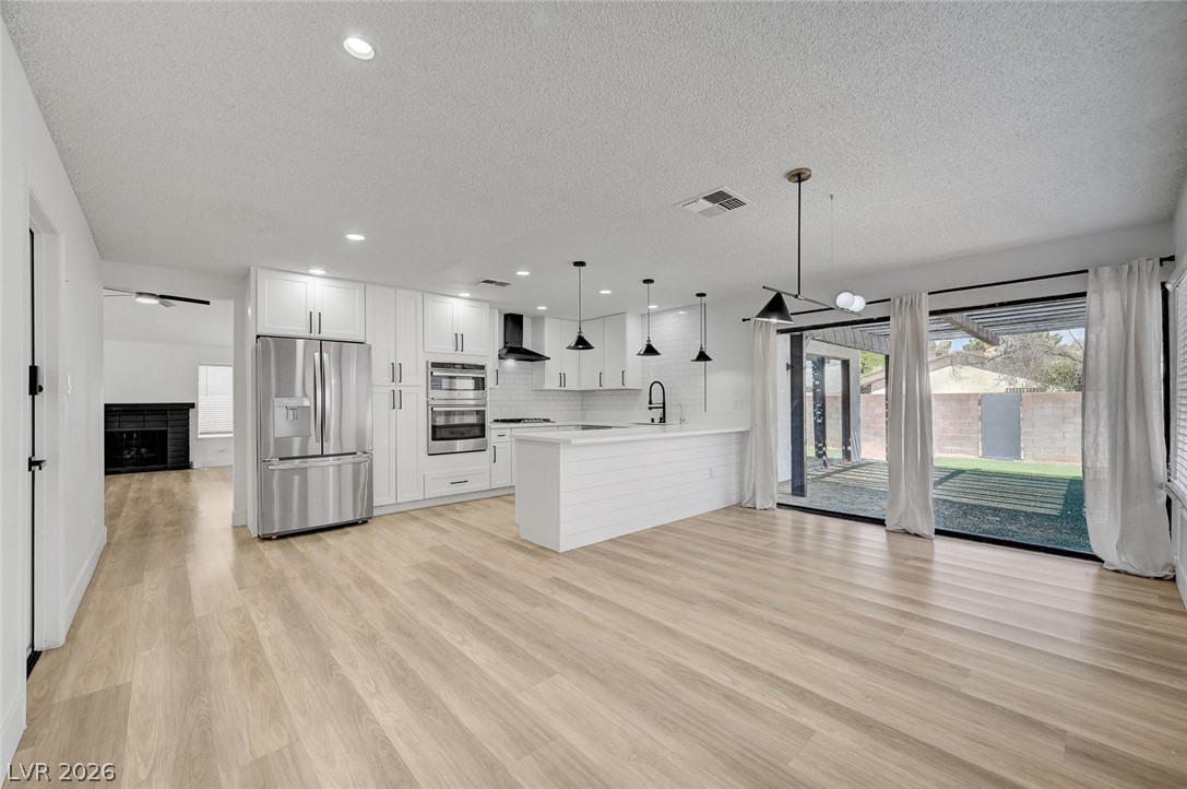 4840 Summerhill Road Las Vegas, NV 89121 - Photo 10 of 56 Bright, open-concept kitchen and living area with seamless indoor-outdoor access to the private yard.
