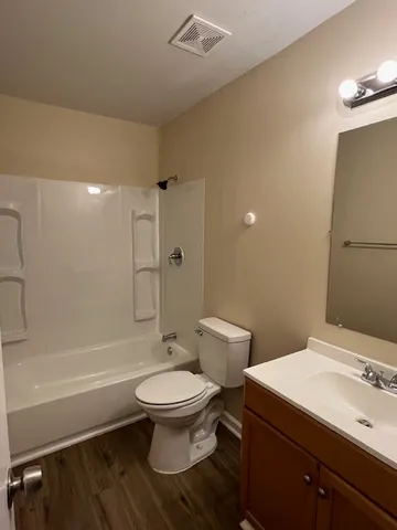 a bathroom with a toilet a sink and bathtub