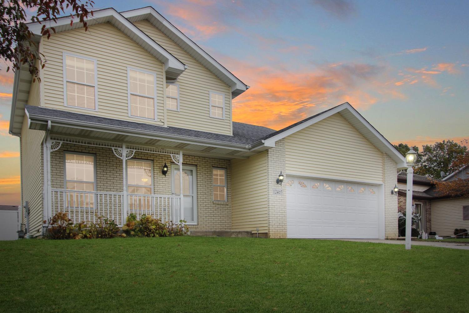 a front view of the house with a yard
