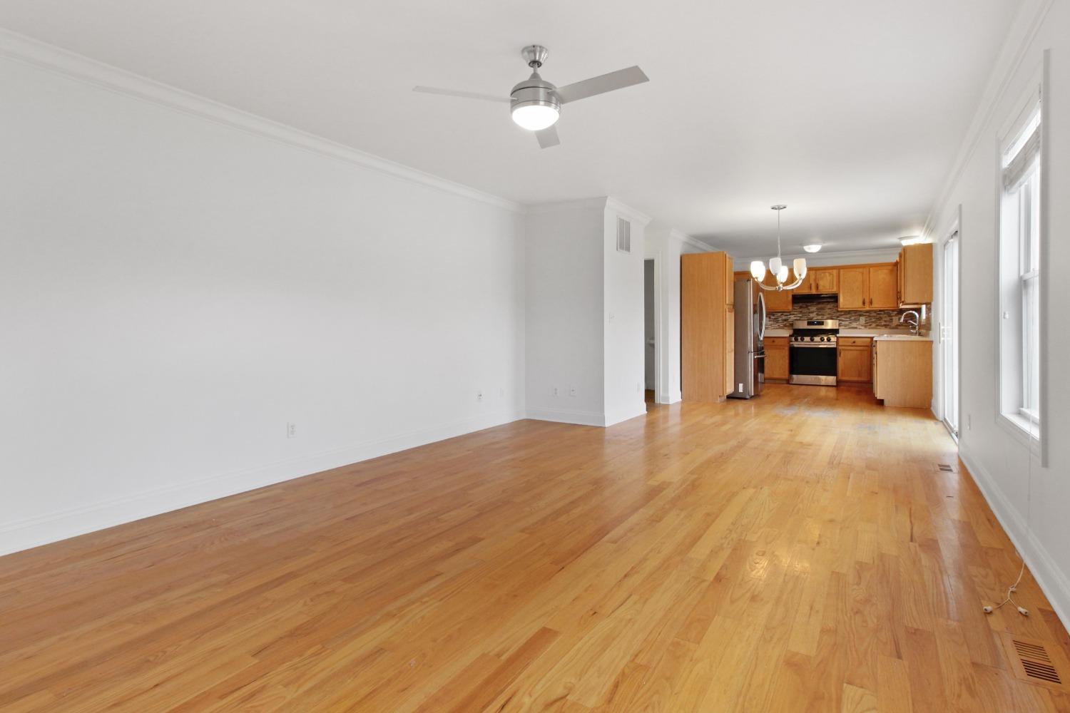 12465 Shelby Place Crown Point, IN 46307 - Photo 12 of 25 a view of a livingroom with furniture wooden floor a ceiling fan and windows