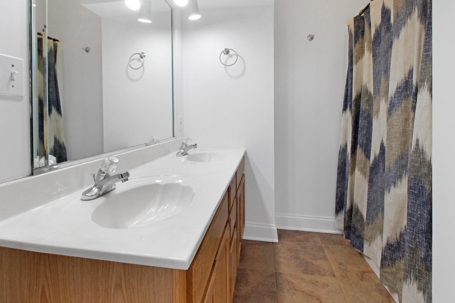 12465 Shelby Place Crown Point, IN 46307 - Photo 17 of 25 a bathroom with a sink and a mirror