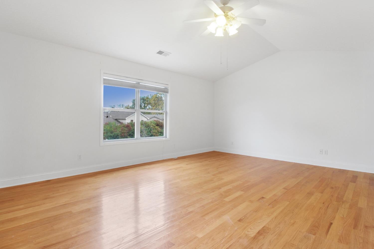12465 Shelby Place Crown Point, IN 46307 - Photo 20 of 25 a view of an empty room with wooden floor and a window