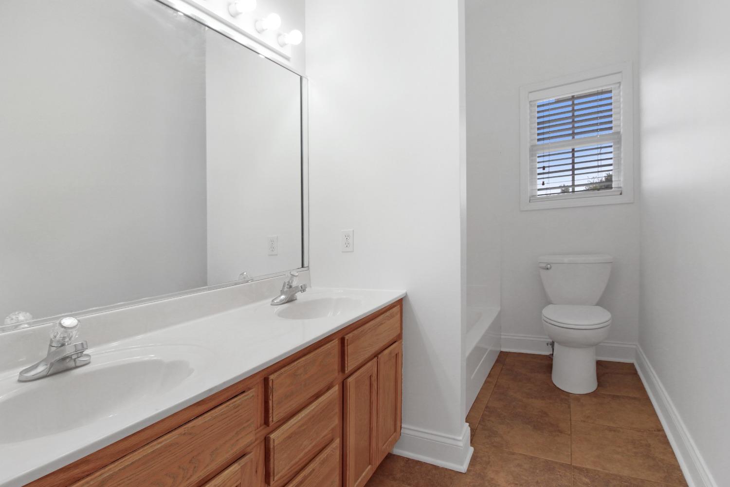 12465 Shelby Place Crown Point, IN 46307 - Photo 21 of 25 a bathroom with a sink a toilet and a mirror