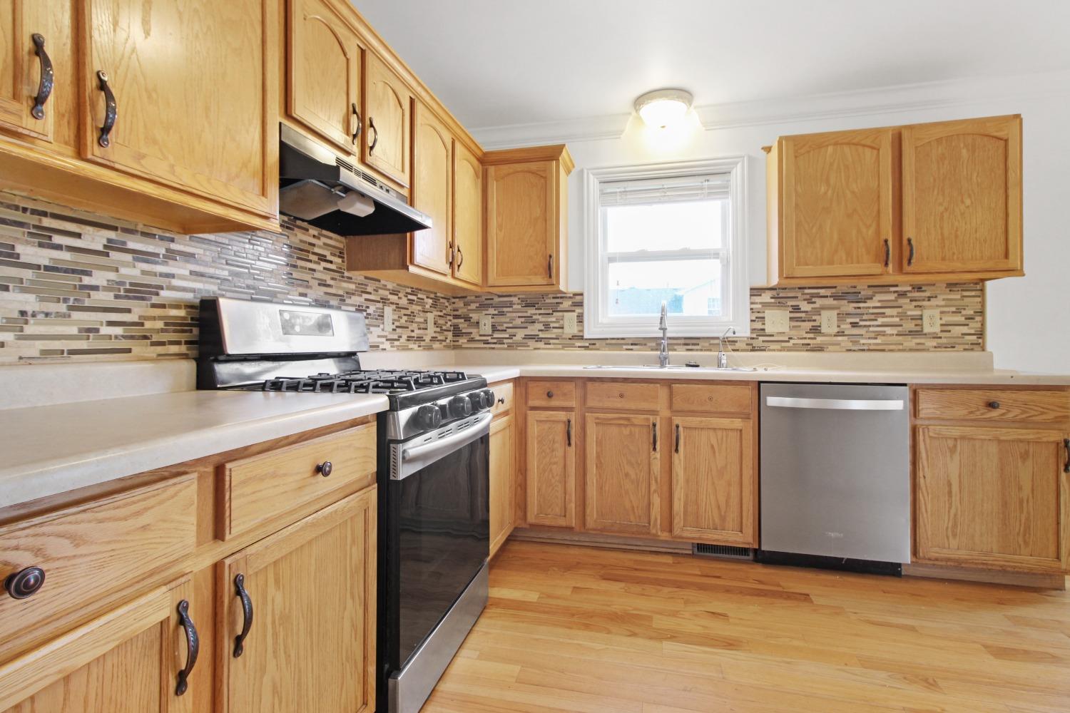 12465 Shelby Place Crown Point, IN 46307 - Photo 9 of 25 a kitchen with stainless steel appliances granite countertop a sink stove and cabinets