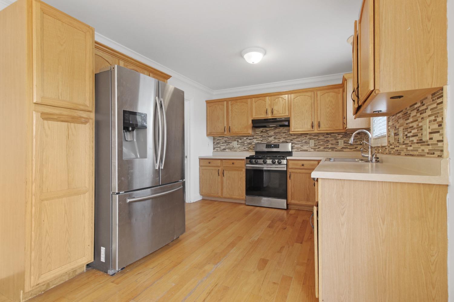 12465 Shelby Place Crown Point, IN 46307 - Photo 10 of 25 a kitchen with a refrigerator a sink and a stove