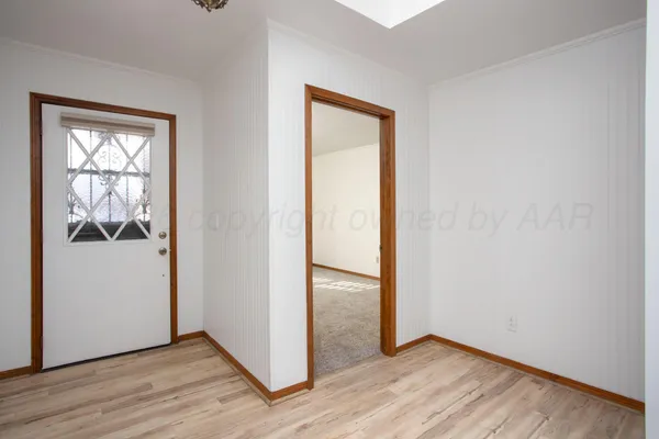 an empty room and wooden door
