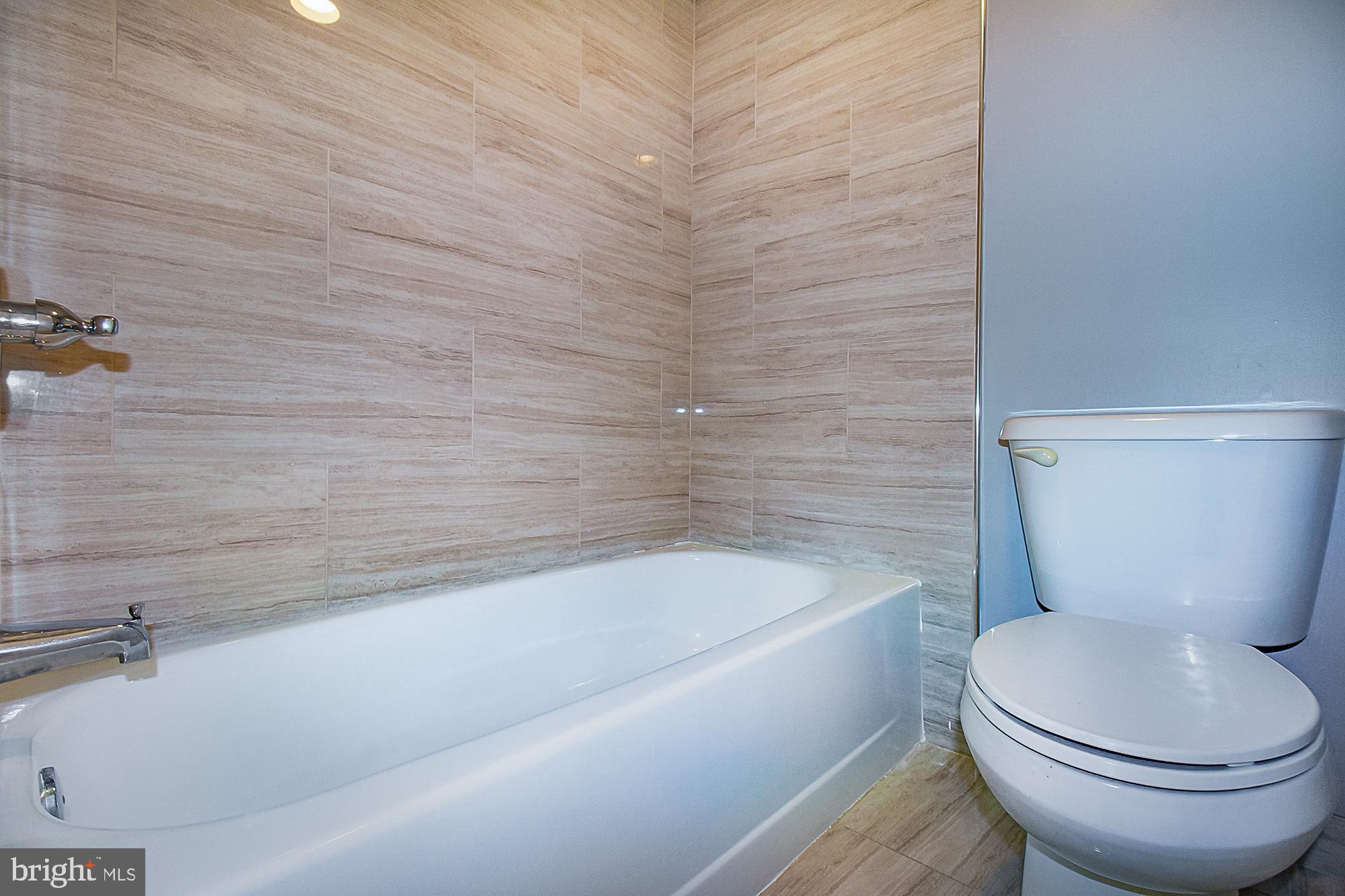 5505 Seminary Road, Unit 1003N Falls Church, VA 22041 - Photo 15 of 27 Floor-to-ceiling tile enhances the tub/shower.
