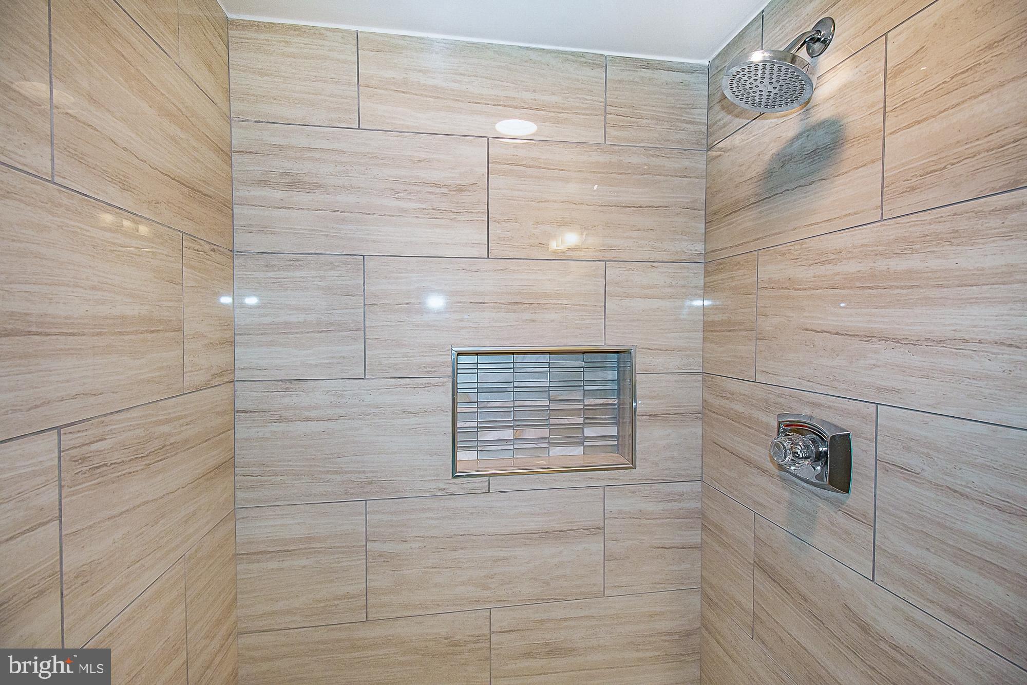 5505 Seminary Road, Unit 1003N Falls Church, VA 22041 - Photo 23 of 27 Designer glass shower niche. Floor 2 ceiling tile.