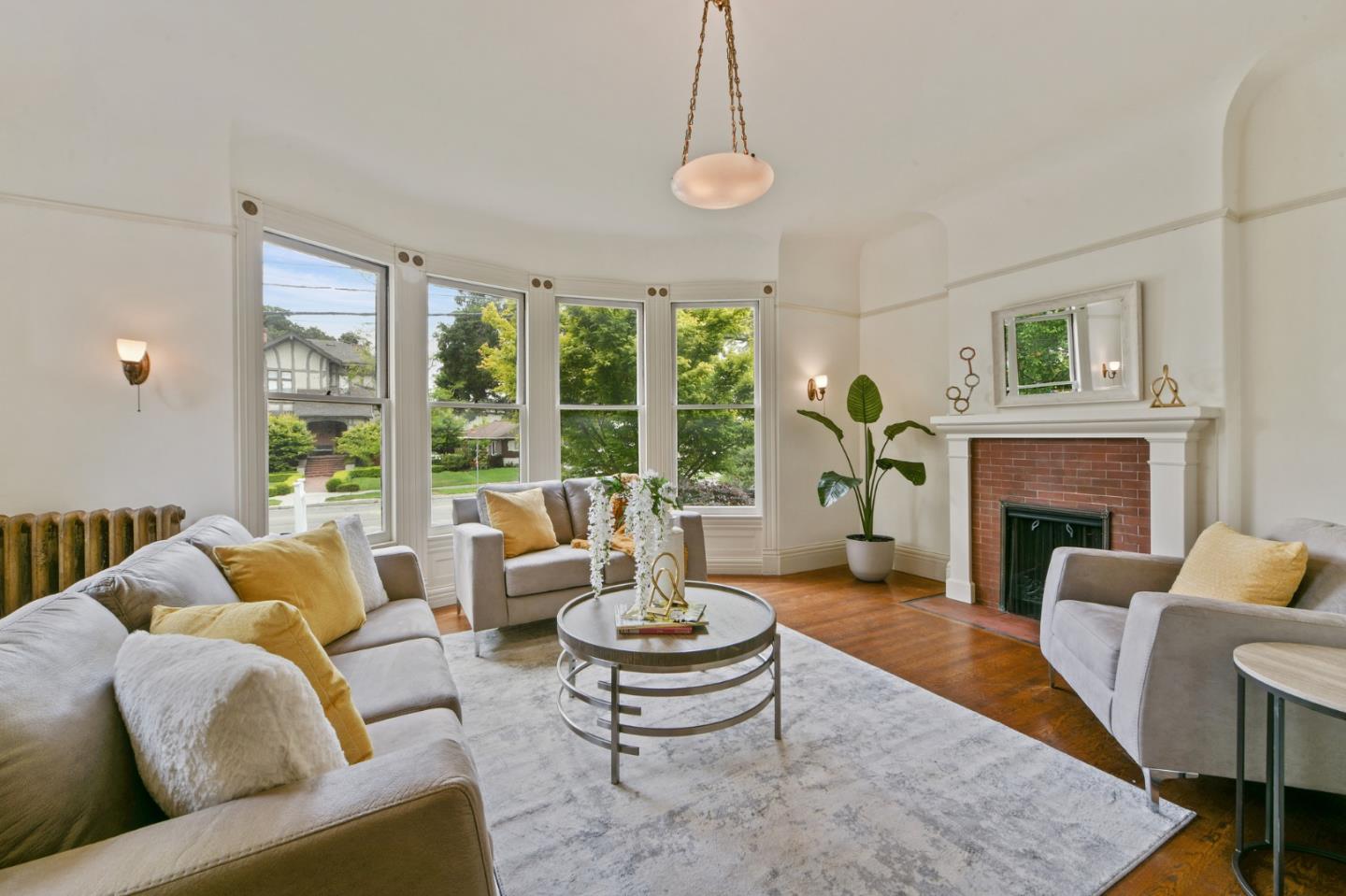1106 Grand Street Alameda, CA 94501 - Photo 14 of 100 a living room with furniture a fireplace and a large window