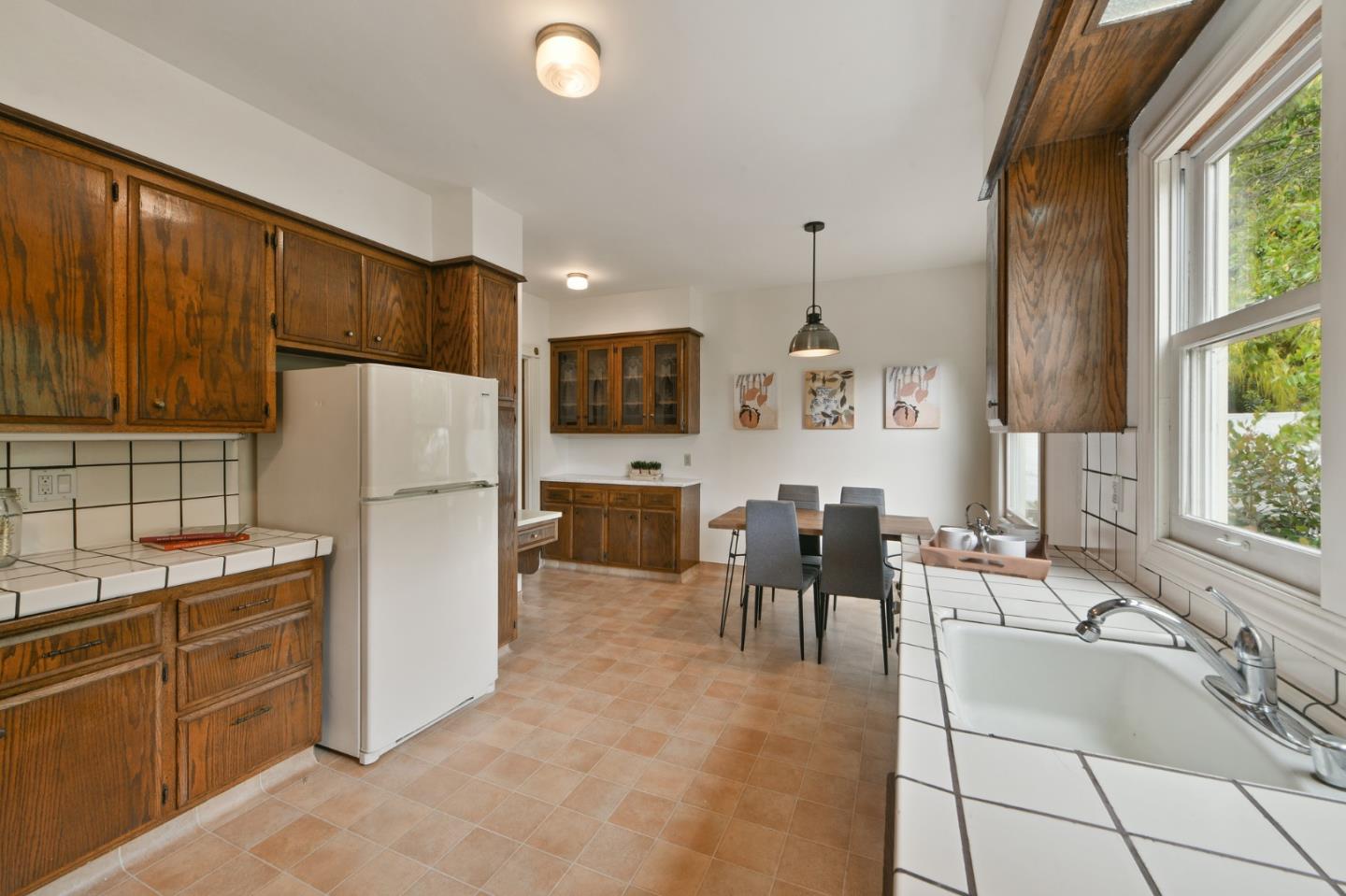 1106 Grand Street Alameda, CA 94501 - Photo 37 of 100 a living room with furniture a flat screen tv and a refrigerator