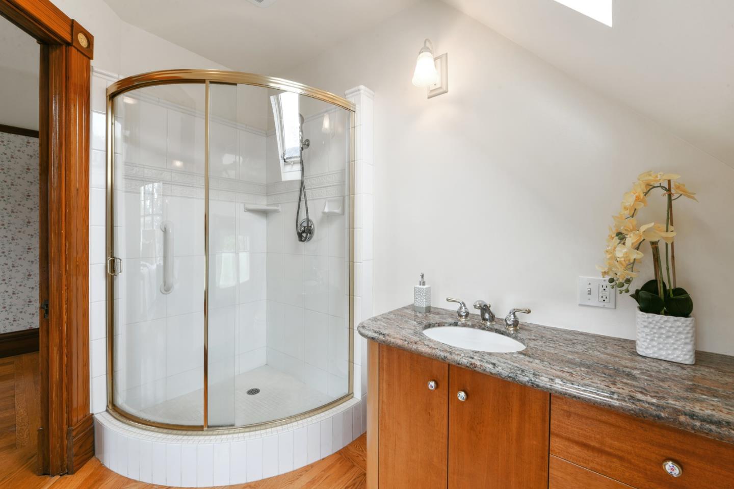 1106 Grand Street Alameda, CA 94501 - Photo 55 of 100 a bathroom with a granite countertop sink a mirror and shower