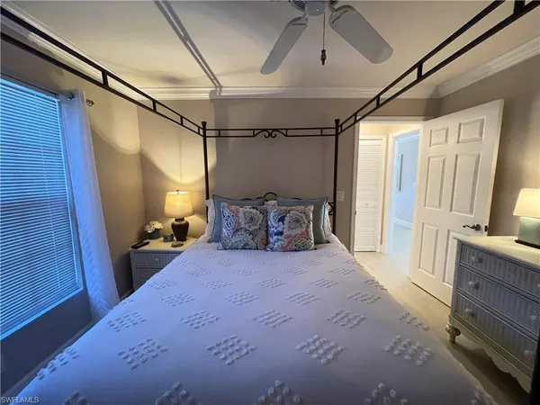 a bedroom with a bed and a mirror