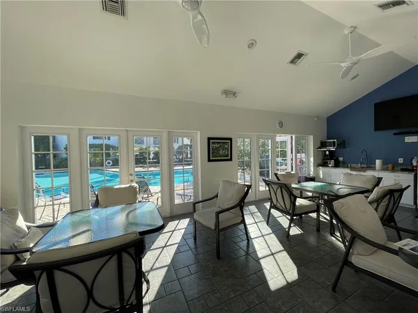 a living room with furniture and a floor to ceiling window