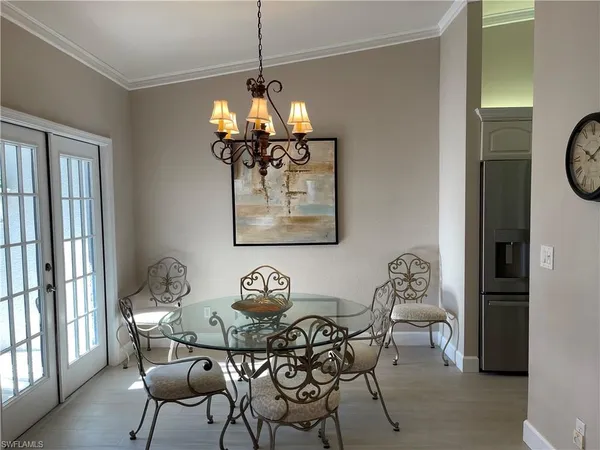 a view of a dining room with furniture wooden floor and a chandelier