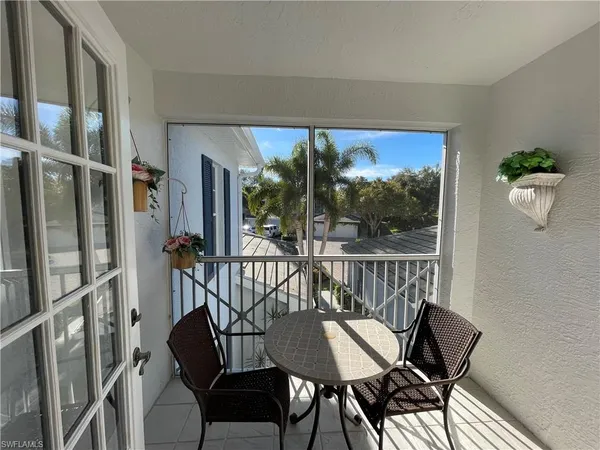 a view of a chairs and table in the balcony