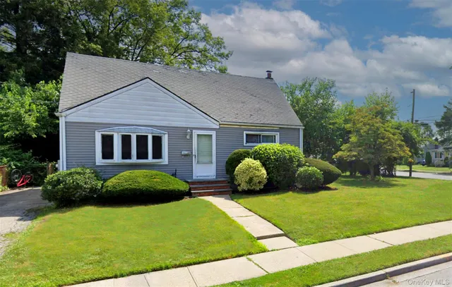 a view of a house with a yard and plants