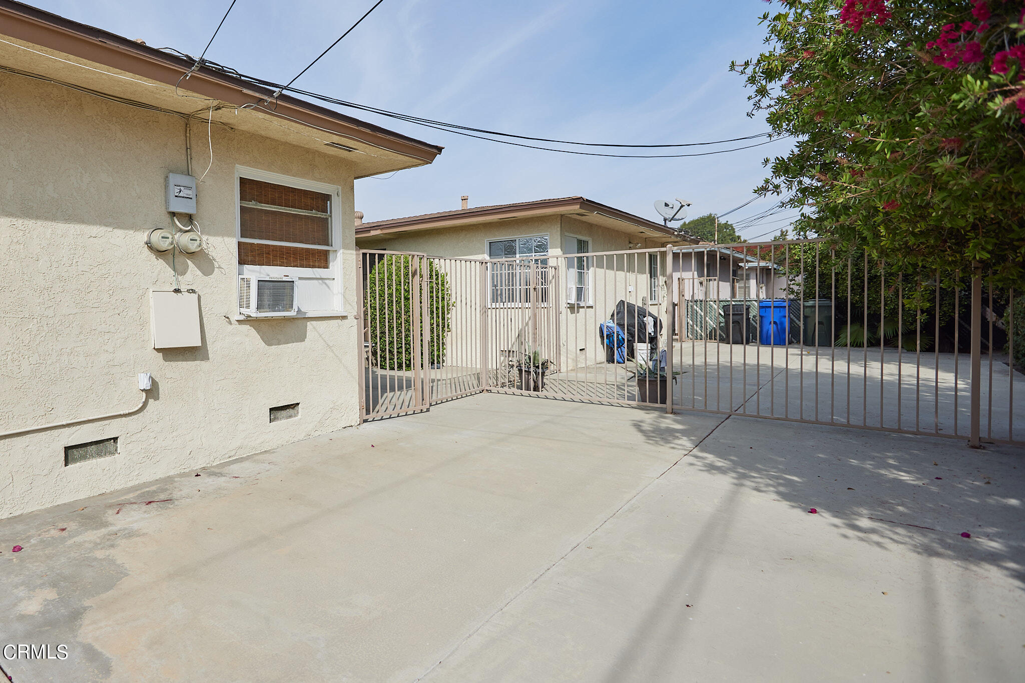 10520 Myrtle Street Downey, CA 90241 - Photo 6 of 8 a view of a white house with large windows and a small yard