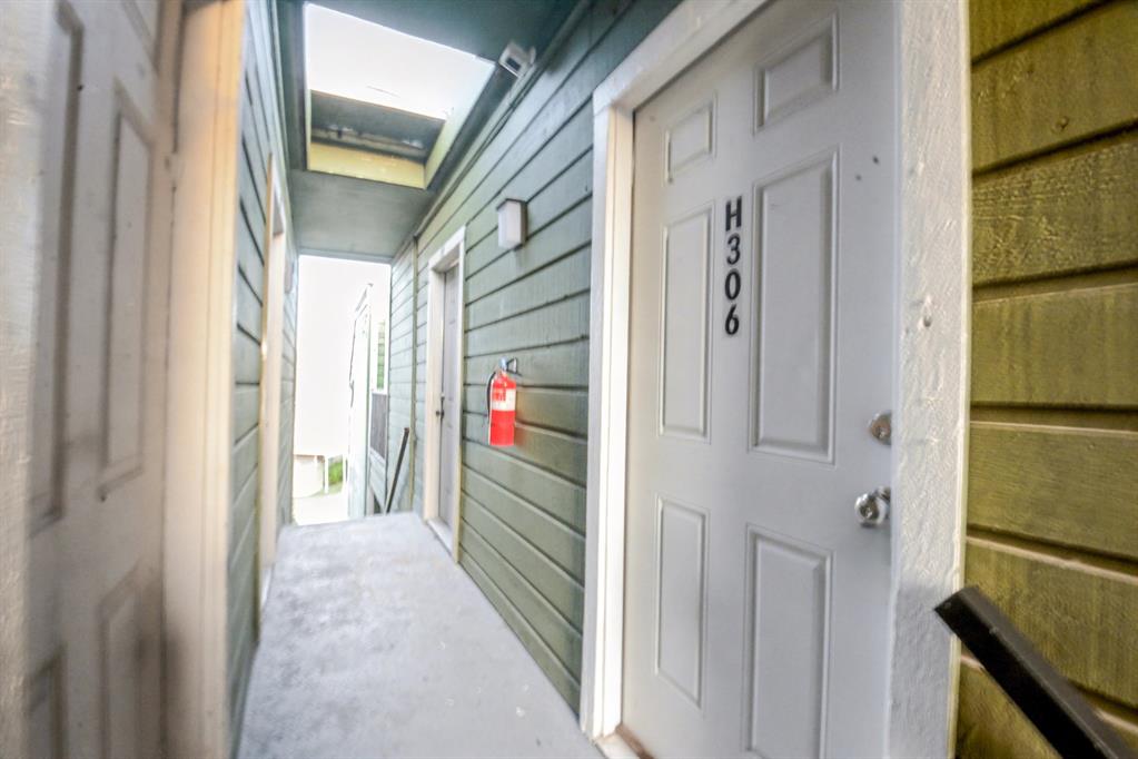 9815 Walnut Street, Unit H306 Dallas, TX 75243 - Photo 15 of 23 a view of a hallway with wooden shelves