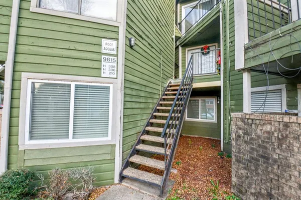 a view of balcony with wooden floor and fence