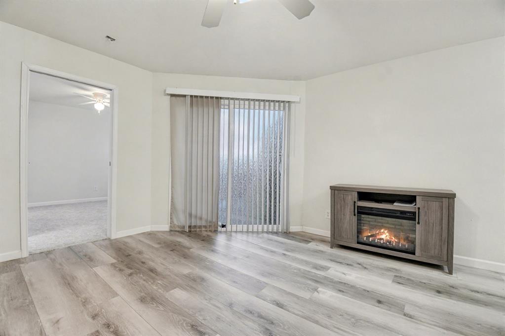 9815 Walnut Street, Unit H306 Dallas, TX 75243 - Photo 3 of 23 a view of an empty room with fire place and a window