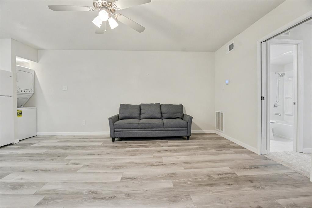 9815 Walnut Street, Unit H306 Dallas, TX 75243 - Photo 5 of 23 a living room with furniture and a chandelier