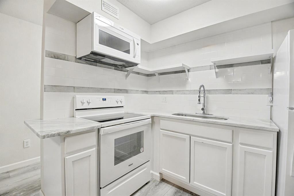 9815 Walnut Street, Unit H306 Dallas, TX 75243 - Photo 6 of 23 a kitchen with cabinets stainless steel appliances and sink