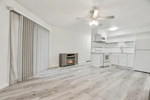 a kitchen with cabinets and a refrigerator