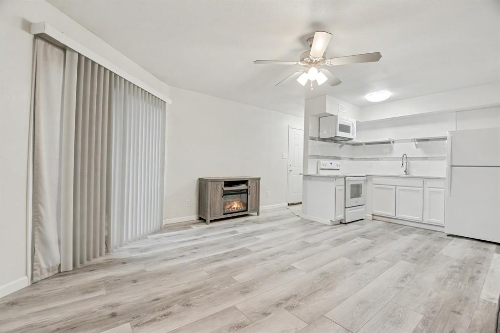 9815 Walnut Street, Unit H306 Dallas, TX 75243 - Photo 7 of 23 a view of a kitchen with a sink cabinets and a ceiling fan