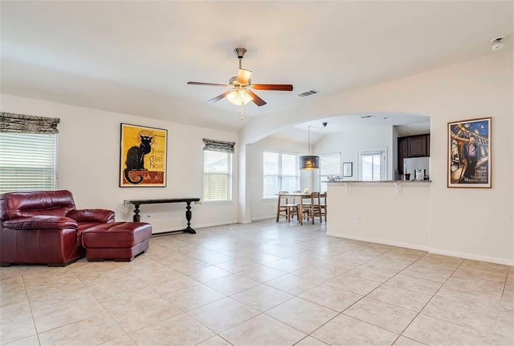 104 Beech Creek Lane Leander, TX 78641 - Photo 5 of 13 Living room with light tile patterned flooring, ceiling fan, and lofted ceiling