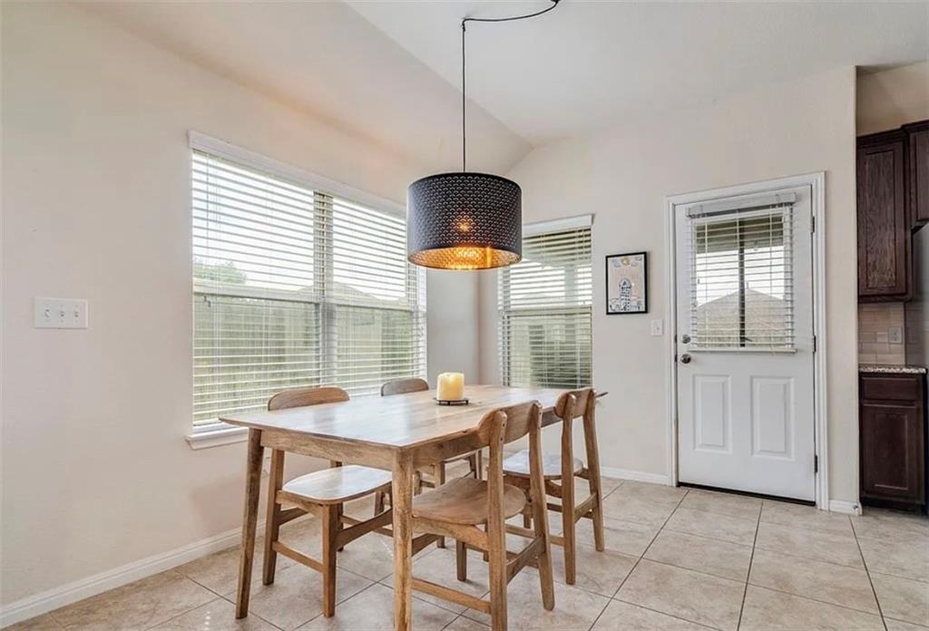 104 Beech Creek Lane Leander, TX 78641 - Photo 6 of 13 Dining area featuring vaulted ceiling and light tile patterned floors