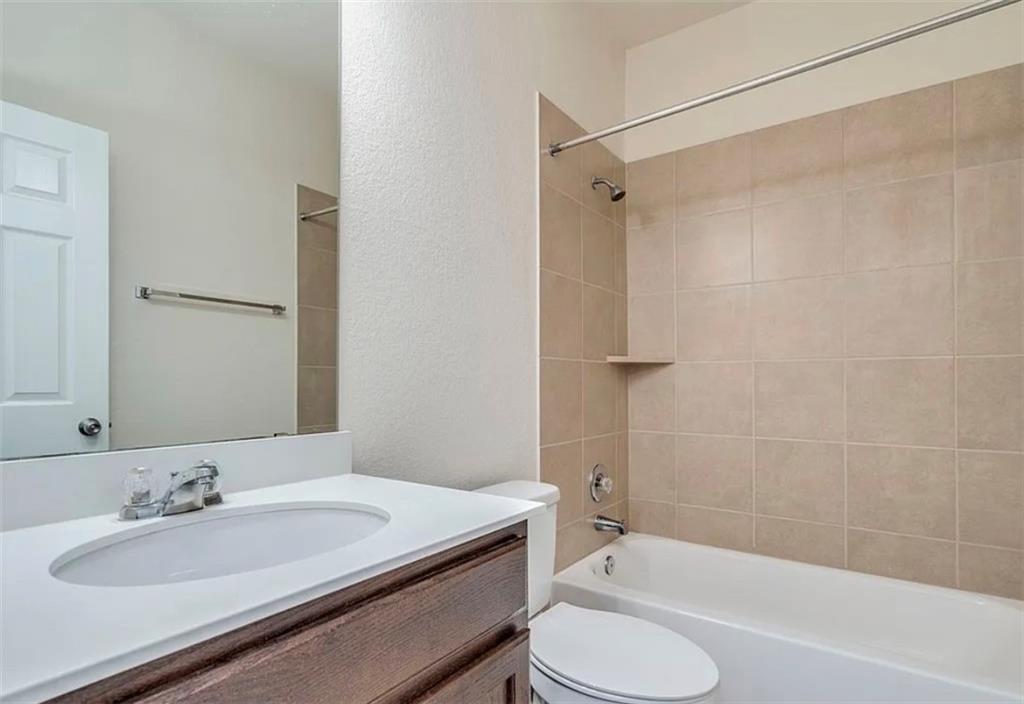 104 Beech Creek Lane Leander, TX 78641 - Photo 8 of 13 Full bath with vanity, bathing tub / shower combination, and a textured wall