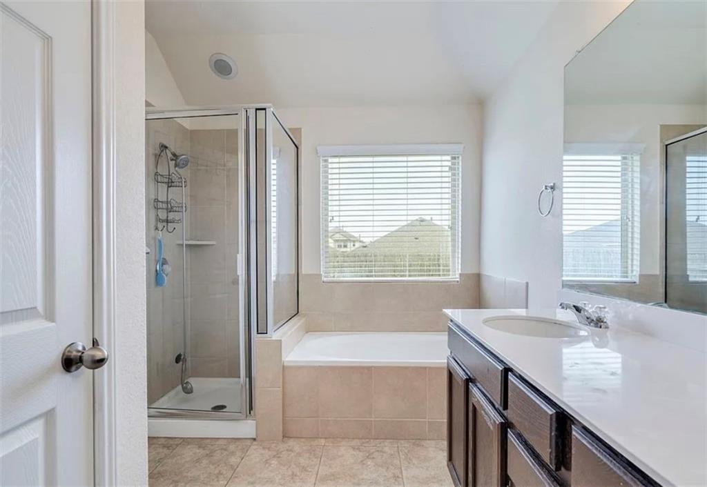 104 Beech Creek Lane Leander, TX 78641 - Photo 10 of 13 Full bathroom with vanity, a garden tub, a shower stall, and light tile patterned flooring