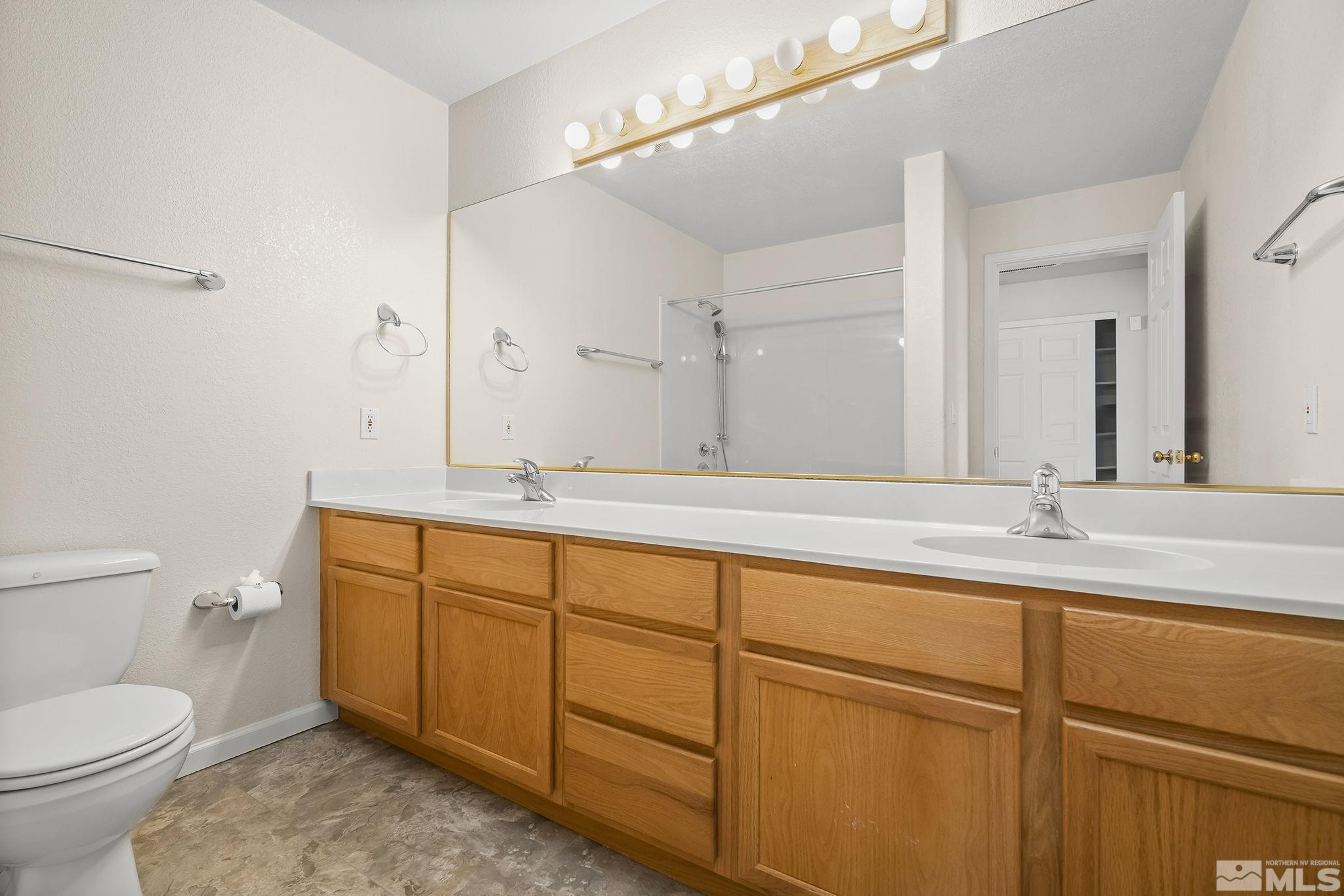 1352 Antelope Valley Road Reno, NV 89506 - Photo 14 of 36 a bathroom with a granite countertop sink mirror vanity and toilet