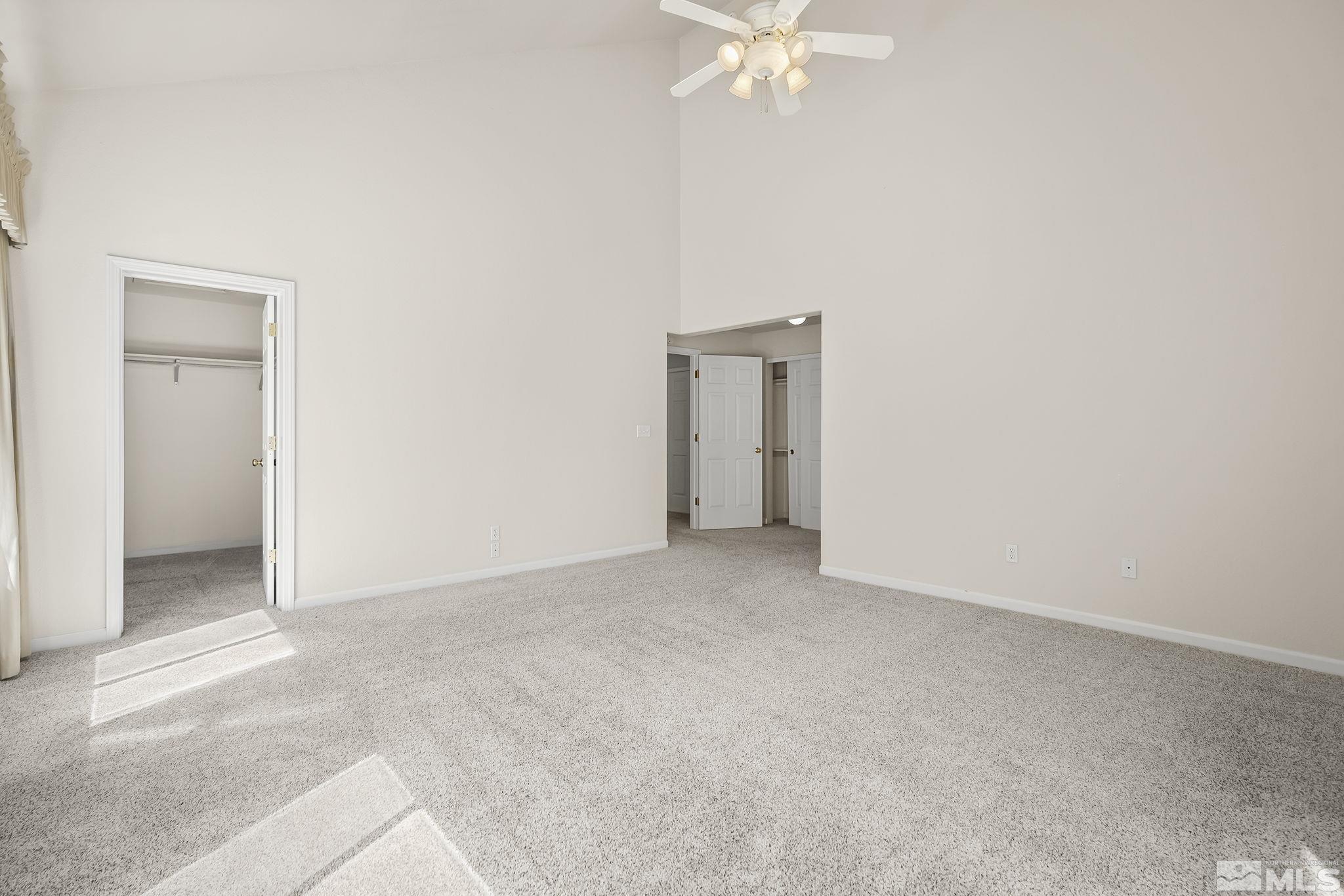 1352 Antelope Valley Road Reno, NV 89506 - Photo 16 of 36 an empty room with a chandelier fan